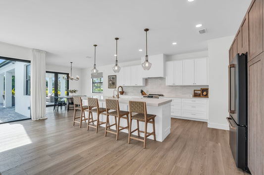 Modern transitional style kitchen and dining area with Stoneform color Honey by Becki Owens from Hewn Floor- flooring that's built to last and made primarily of limestone