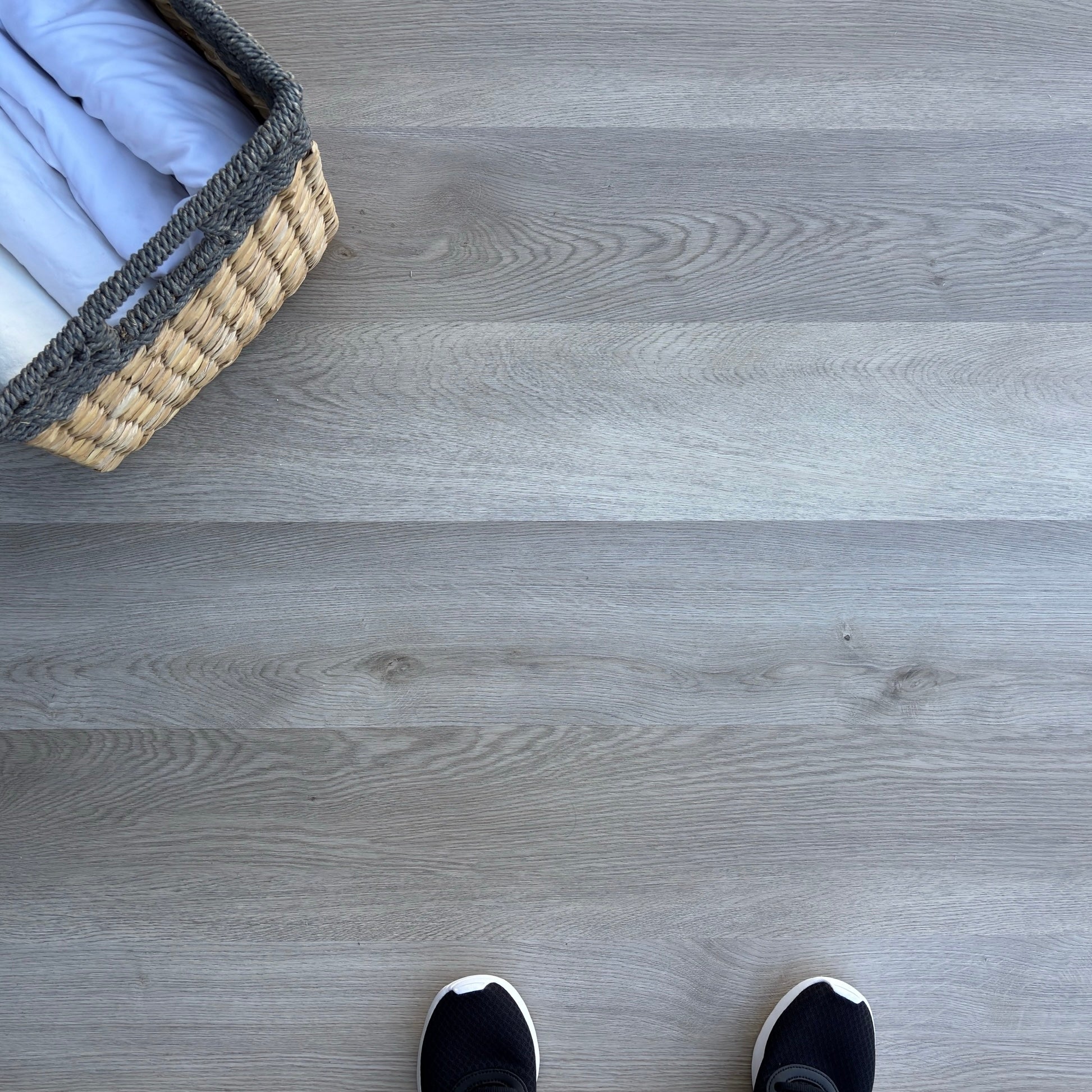 A top-down photo of the flooring color Rustic from the Hewn Floor Becki Owens Select Stoneform Luxury Plank Flooring Collection