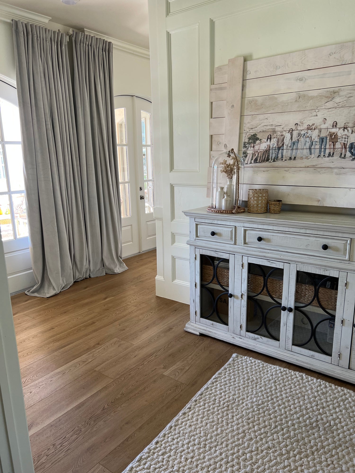 Photo of Hewn Stoneform Luxury Plank Flooring in a dining room with a sideboard table