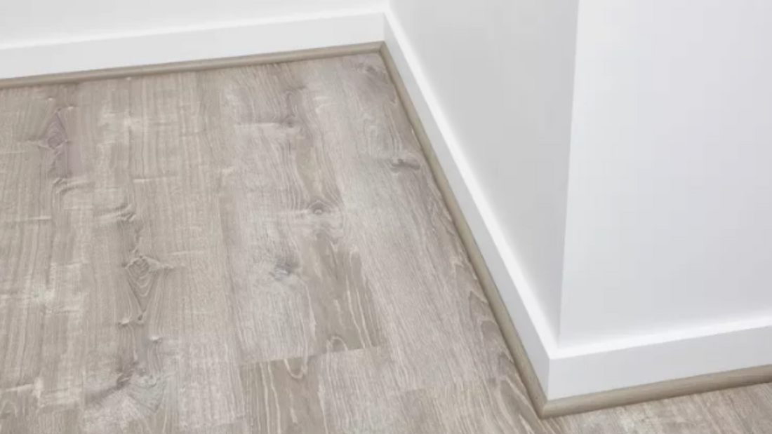 Hewn's Quarter Round Trim installed against a baseboard. 