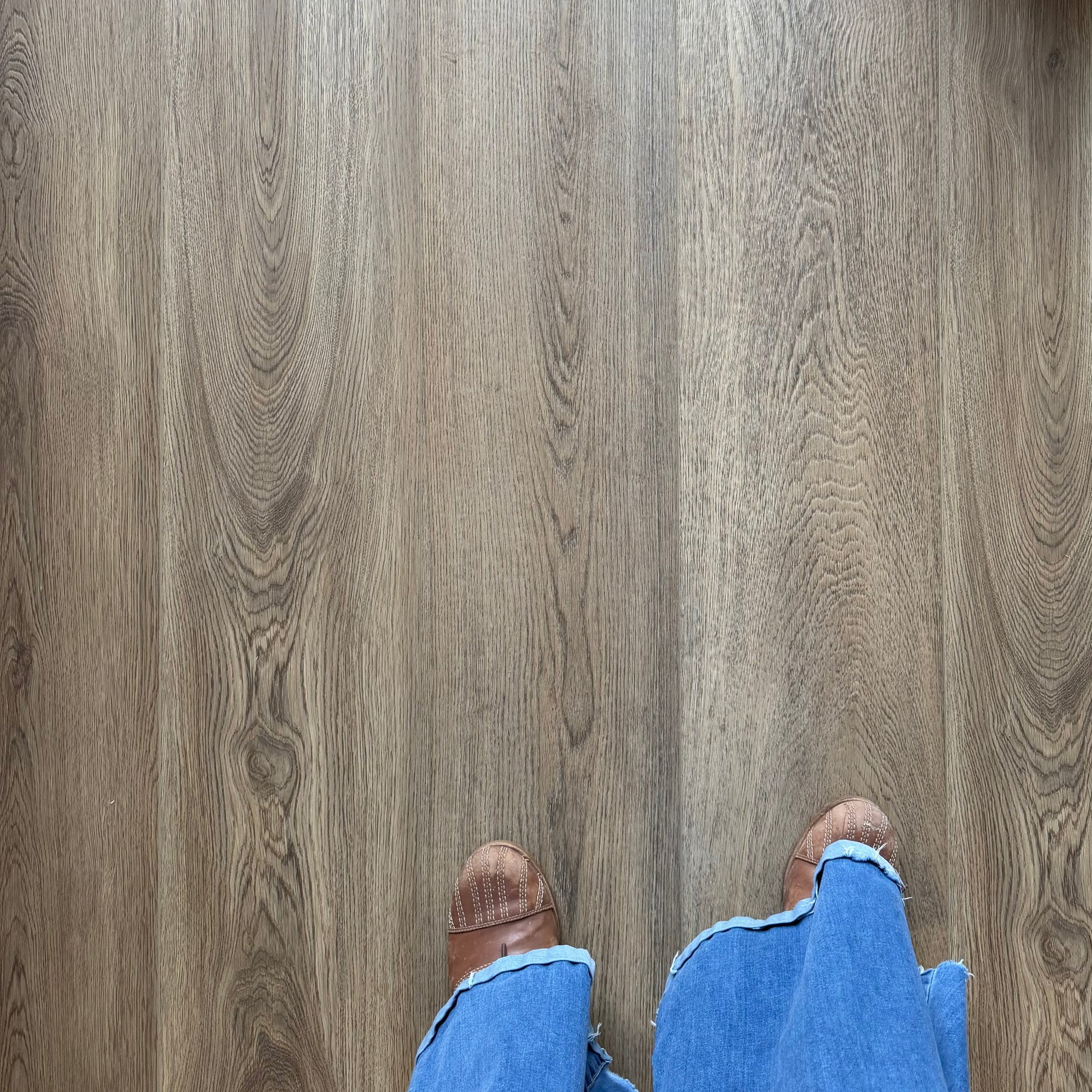 A Photo of Hewn Floor Color Sutterlin in the Galey Alix Elite Stoneform Luxury Vinyl Plank Collection