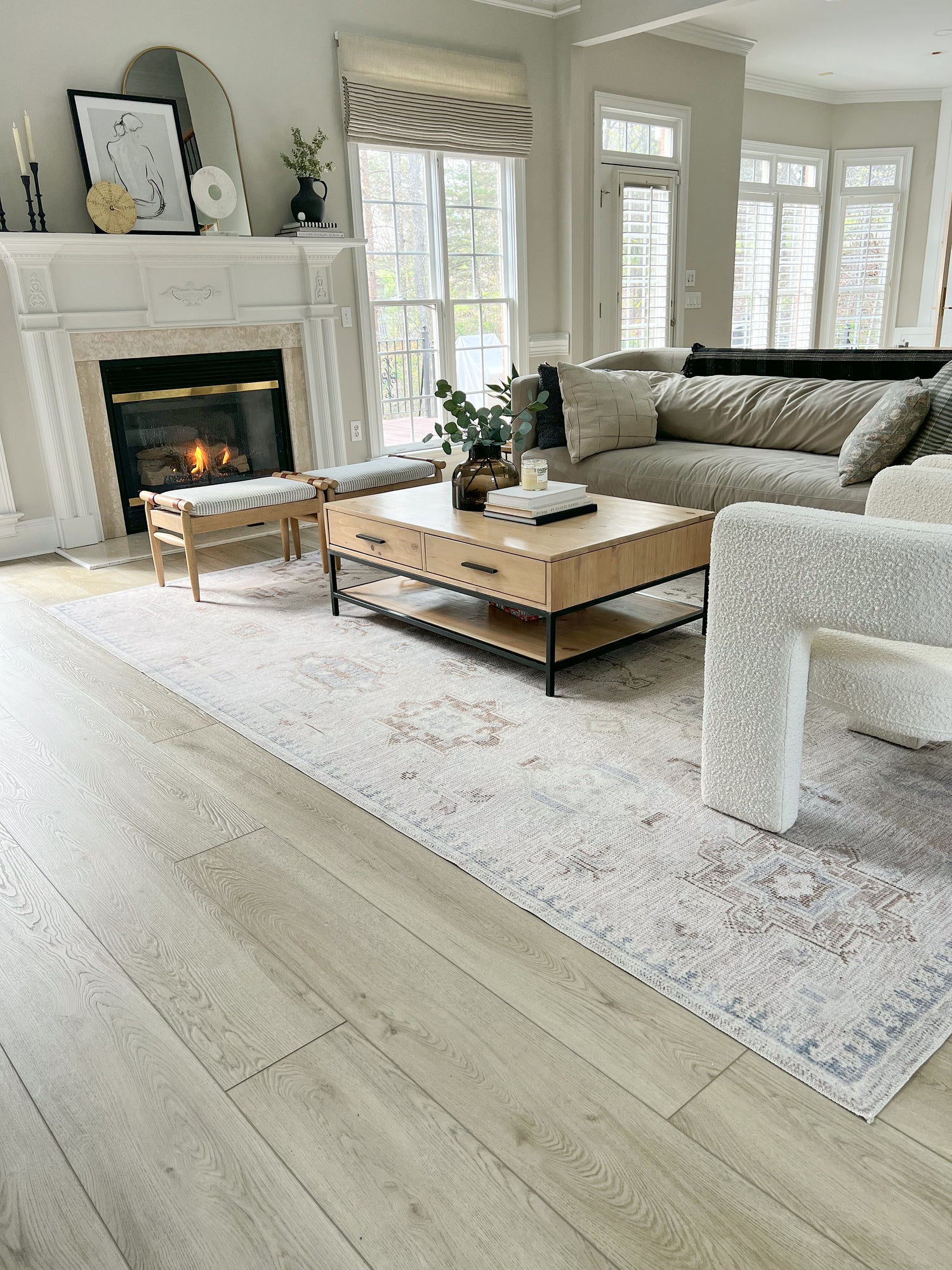 Photo of Hewn Stoneform Luxury Plank Flooring in a beautiful living room with a fireplace