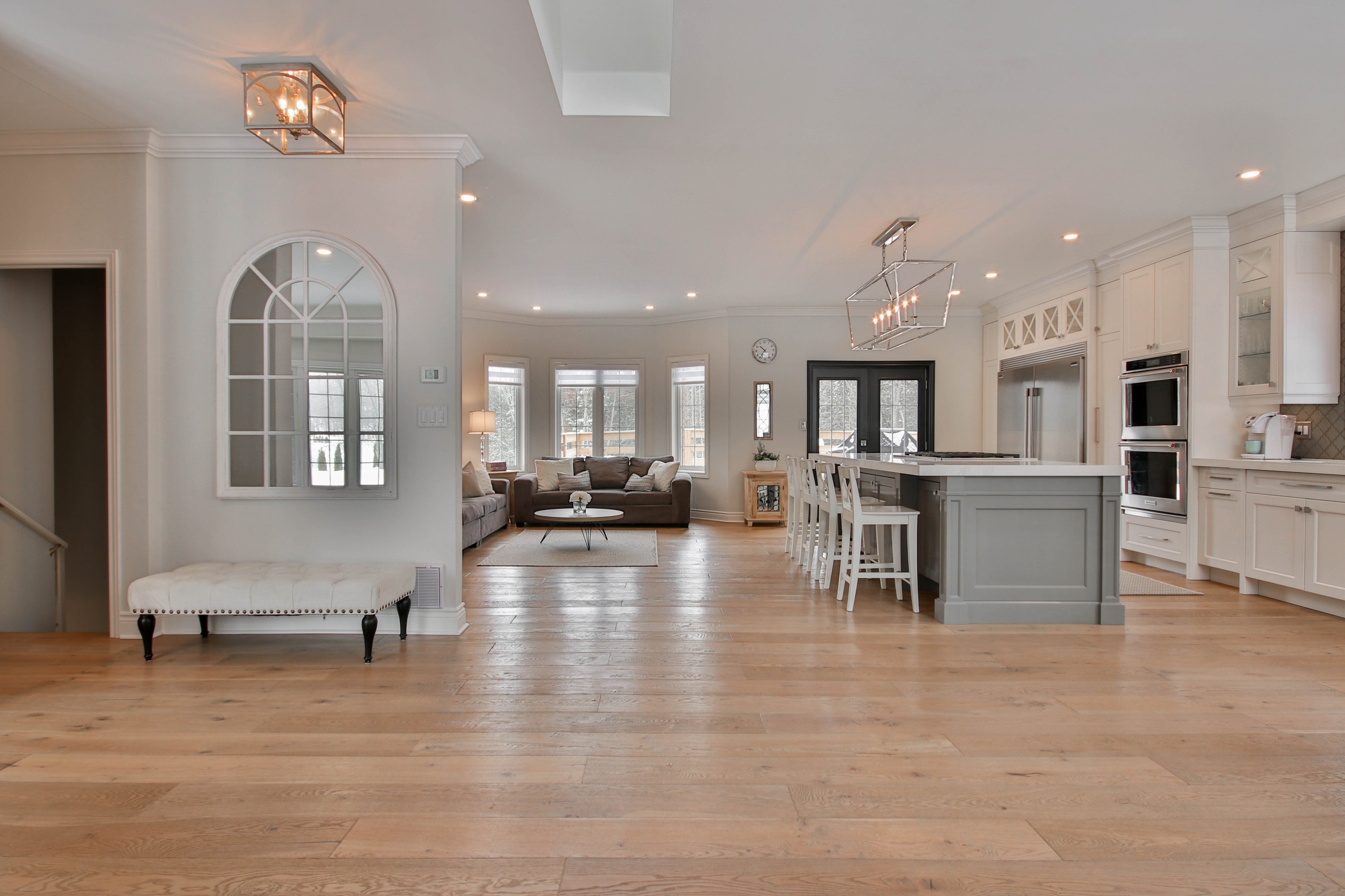 Photo of Hewn Stoneform Luxury Plank Flooring in a beautiful home with an open kitchen