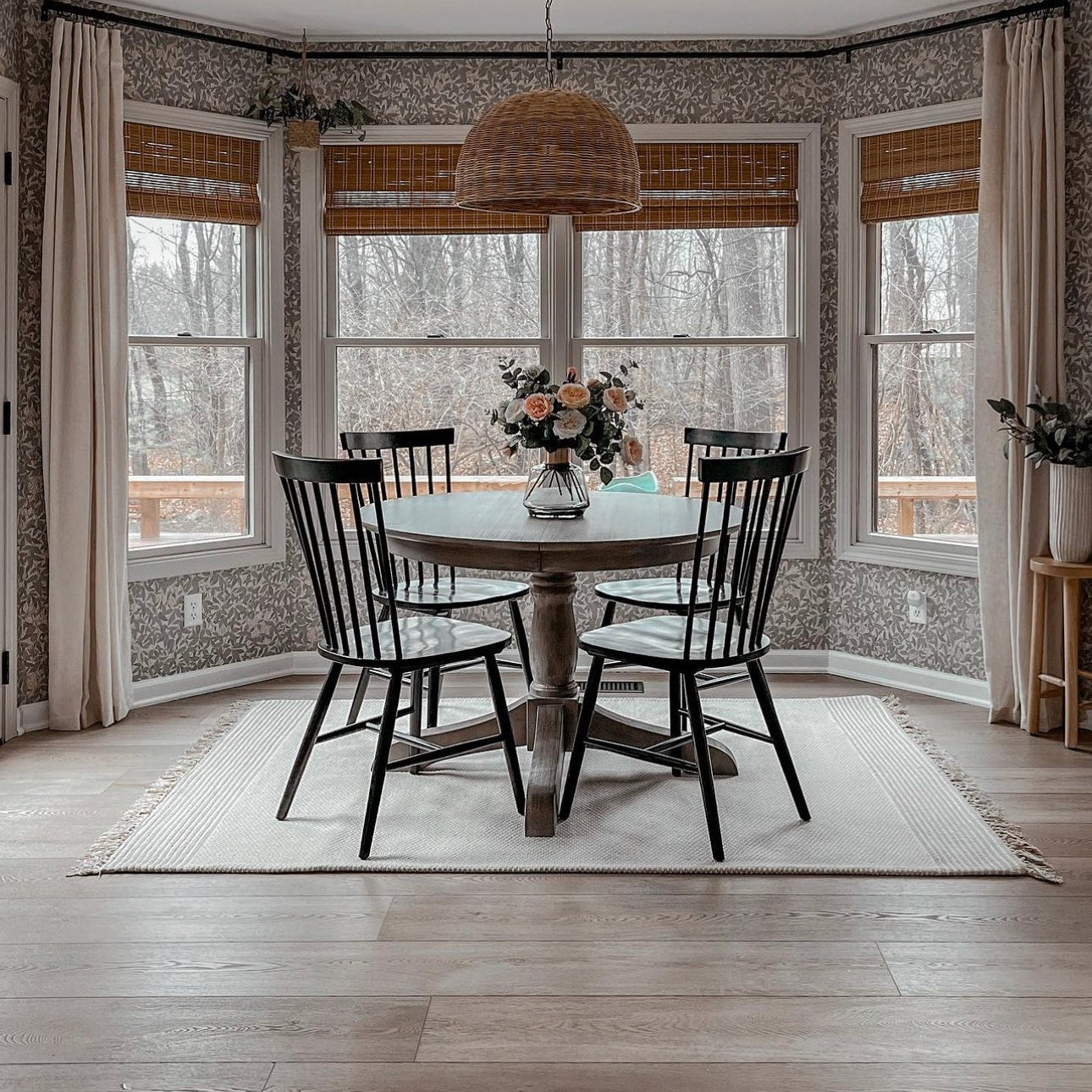 Dining room with wooden table and chairs, and large windows, featuring Hewn Stoneform flooring.